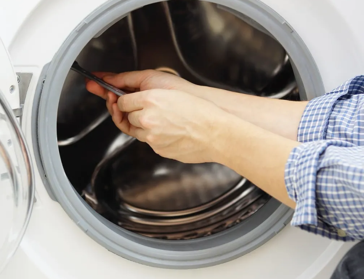 washing machine being fixed